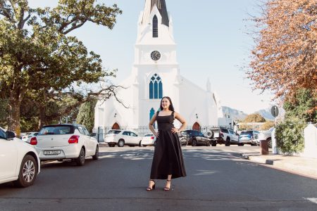 Girl poses for her photoshoot while standing in the middle of the road on Church Street Stellenbosch
